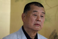 FILE - In this July 1, 2020, file photo, Hong Kong media tycoon Jimmy Lai pauses during an interview in Hong Kong. An aide to Hong Kong media tycoon Jimmy Lai says Lai was arrested Monday morning, Aug. 10, 2020, under the city’s national security law on suspicion of collusion with foreign powers. (AP Photo/Vincent Yu, File)