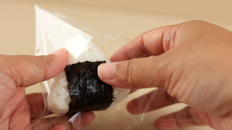 Person wrapping onigiri