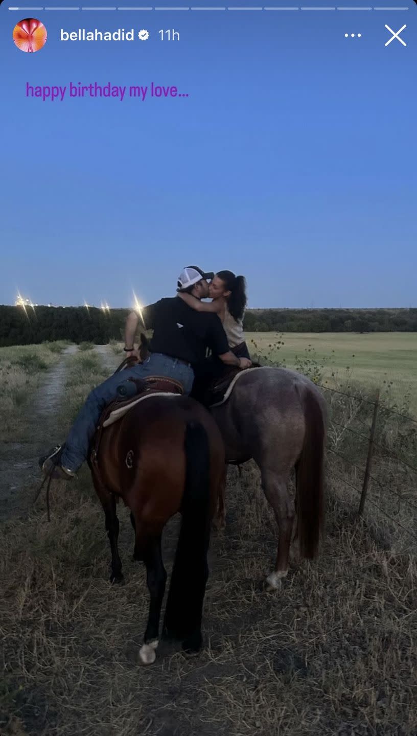 a man and woman kissing on a horse