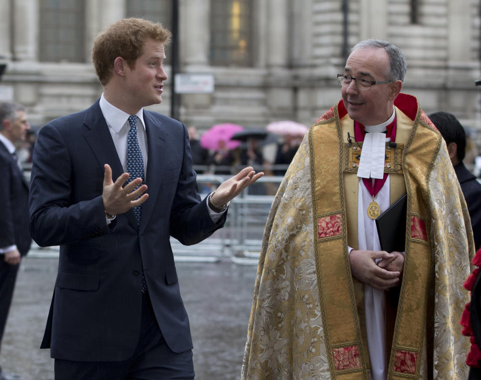 Britain's Prince Harry, left, walks with John Hall, Dean of Westminster Abbey to attend the Nelson Mandela memorial service at the Abbey in London Monday, March 3, 2014. Mandela the former president of South Africa died in December 2013. (AP Photo/Alastair Grant)