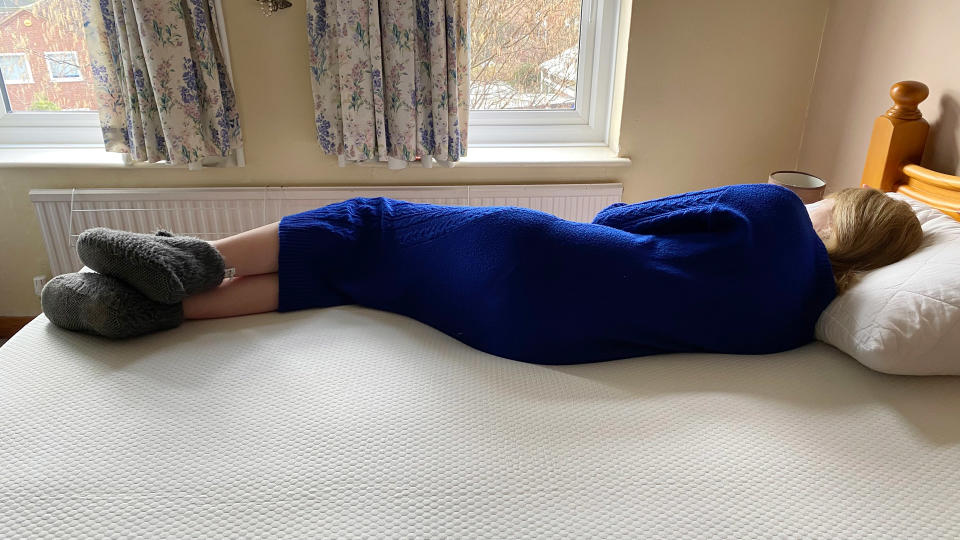 A person lying on the Panda Bamboo Mattress Topper