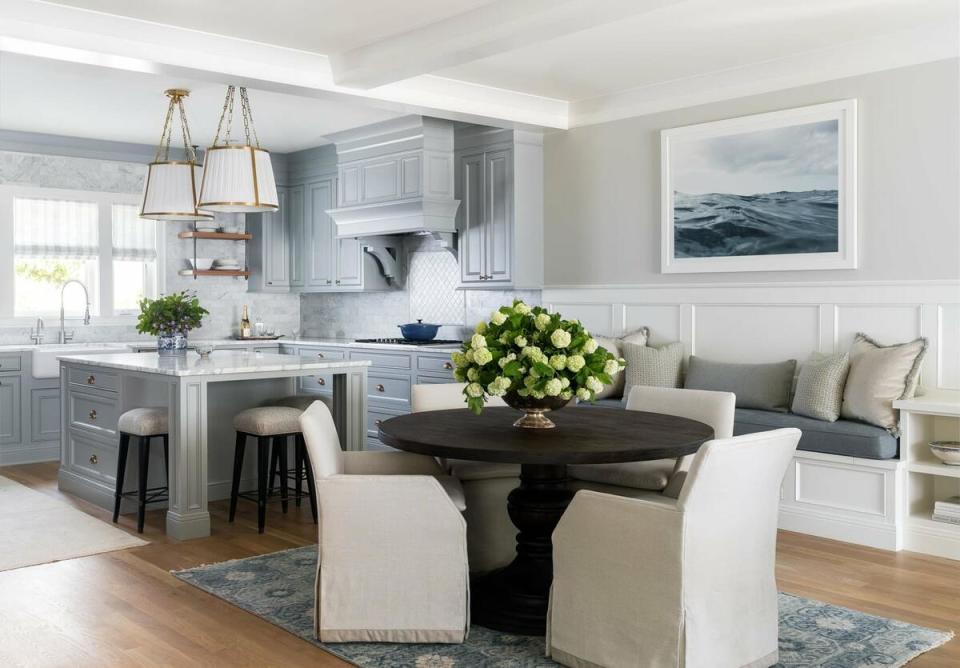 Soft shades of blue unite kitchen and dining spaces