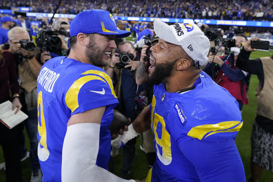 FILE - Los Angeles Rams' Matthew Stafford, left, and Aaron Donald celebrate after the NFC Championship NFL football game against the San Francisco 49ers Sunday, Jan. 30, 2022, in Inglewood, Calif. Stafford, Donald and the Los Angeles Rams will raise their Super Bowl banner Thursday night before kicking off the NFL season at home where they became the first team to hoist the Vince Lombardi trophy in their own stadium. (AP Photo/Marcio Jose Sanchez, File)