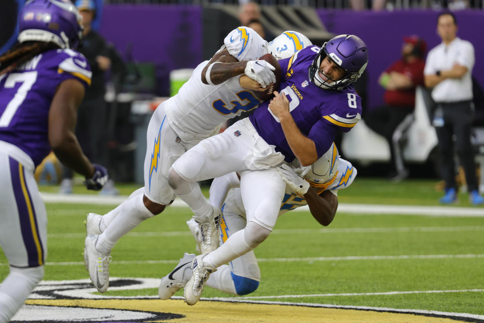 Minnesota Vikings quarterback Kirk Cousins (8) is sacked by Los Angeles Chargers safety Derwin James Jr. (3) during the second half of an NFL football game, Sunday, Sept. 24, 2023, in Minneapolis. (AP Photo/Bruce Kluckhohn)