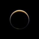 NASA's Cassini spacecraft looks toward the night side of Saturn's moon Titan and sees sunlight scattering its atmosphere, forming a colorful ring. The images were acquired on June 6, 2012, when Cassini was about 134,000 miles from Titan.