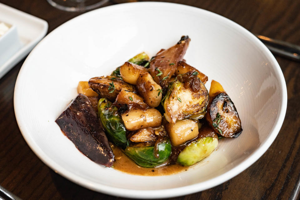 Posana's ricotta gnocchi with roasted rainbow carrots, brussels sprouts, cipollini onion, wine, butter, and thyme.