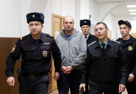 Former Chairman of Vostochny Bank board Alexei Kordichev, who was detained on suspicion of embezzlement, is escorted inside a court building in Moscow, Russia February 15, 2019. REUTERS/Tatyana Makeyeva