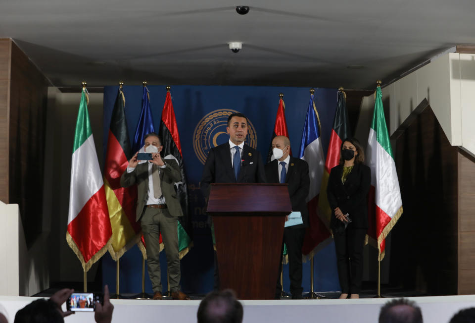 The foreign ministers of Germany, Italy, and France, and Libya, from Left to right, German Foreign Minister Heiko Maas, Italian Foreign Minister Luigi Di Maio, speaking, French Foreign Affairs Minister Jean-Yves Le Drian and Libyan Foreign Minister, Najla el-Mangoush take the stage, in Tripoli, Libya, Thursday, March 25, 2021. The foreign ministers of France, Italy and Germany arrived Thursday in Tripoli to show their support to Libya's newly elected transitional authorities, who are expected to lead the war-stricken country through general elections end of 2021. (AP Photo/Hazem Ahmed)