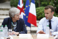 French President Emmanuel Macron, right, meets with British Prime Minister Theresa May to discuss Brexit issues at the Fort de Bregancon in Bornes-les-Mimosas, southern France, Friday Aug. 3, 2018. (Sebastien Nogier, pool via AP)