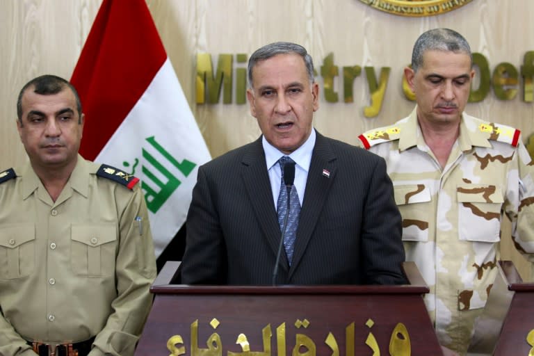 A majority of Iraqi lawmakers voted to oust Defence Minister Khaled al-Obeidi (C) over corruption charges that he denies