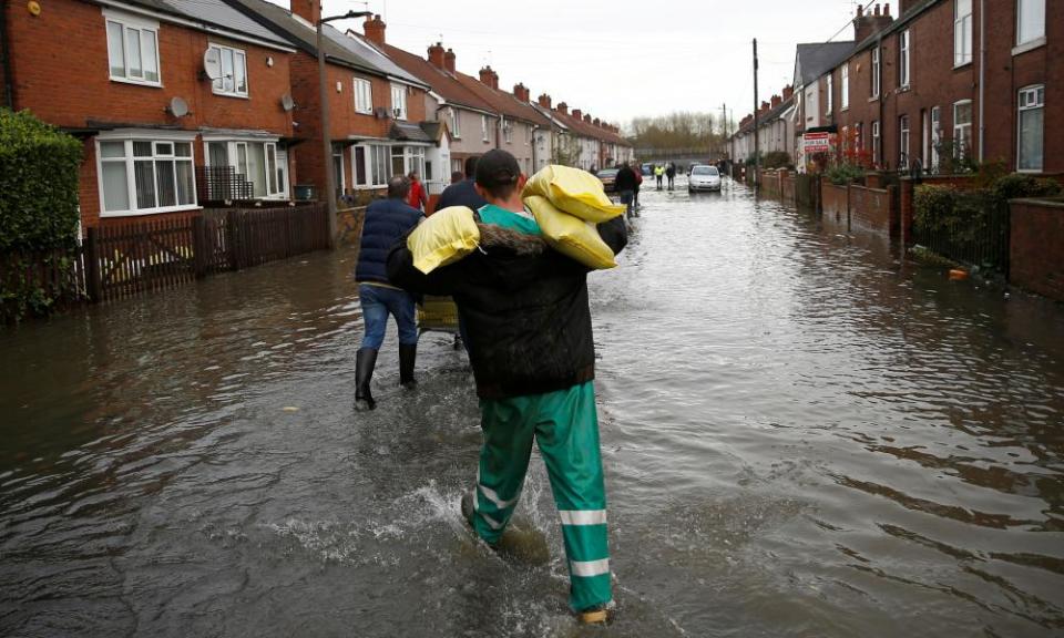 Residents carry sandbags through their street in Bentley.