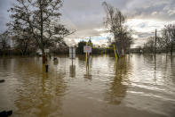 A flood warning sign at the entrance to a flooded car park beside Tewkesbury Abbey, where flood watches are in place with more wet weather expected in the coming days.