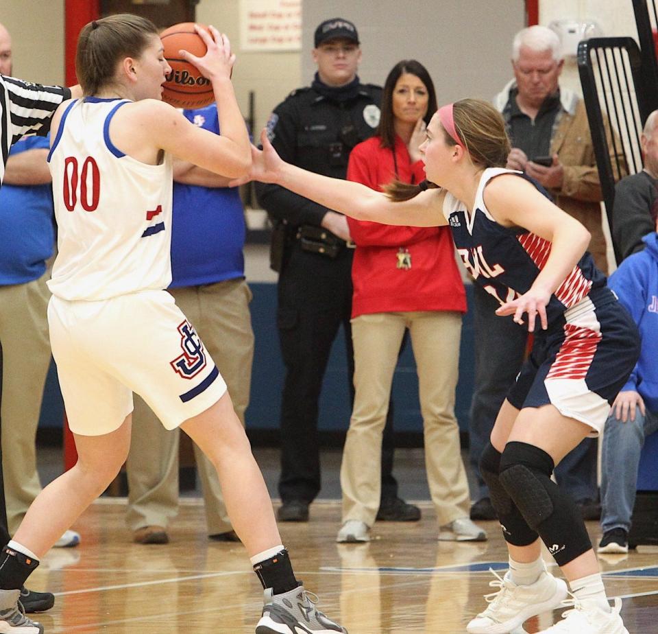 BNL 5-9 senior Carlee Kern (right) defends Jennings County 6-0 star Juliann Woodard during the regular-season duel at North Vernon. Kern limited Woodard to eight points in a 50-34 win.