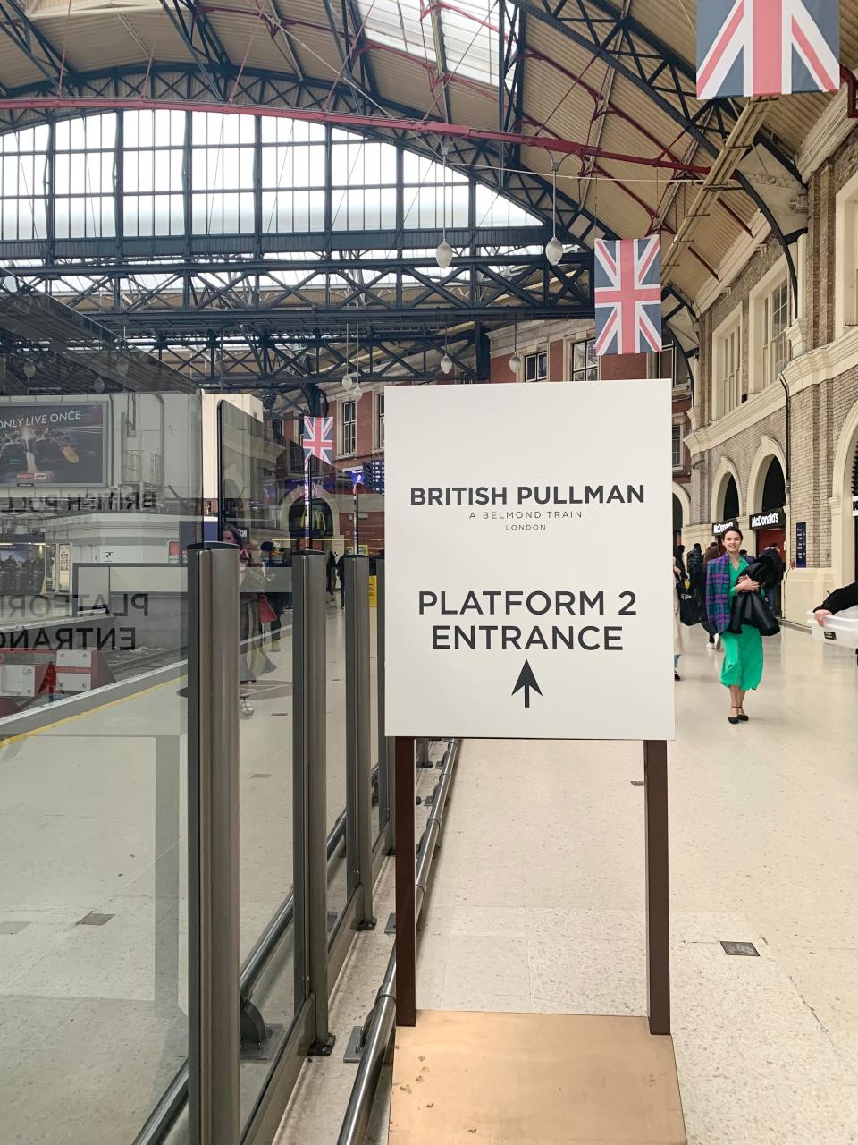 Signs pointing towards the British Pullman train at Victoria Station, London.