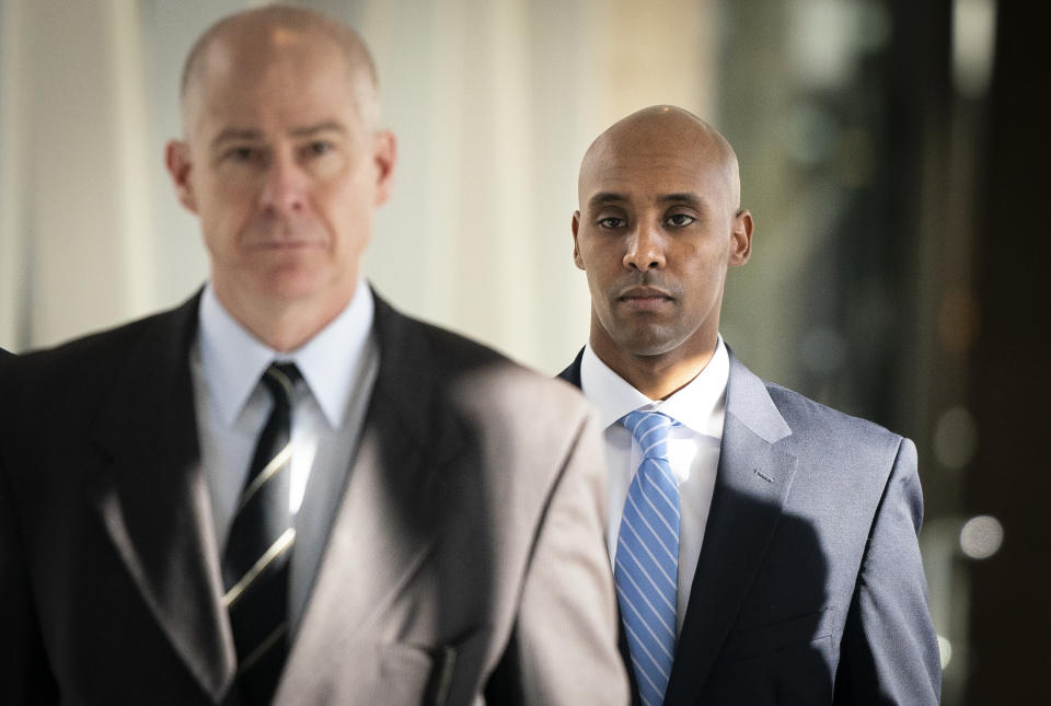 Former Minneapolis police officer Mohamed Noor walks through the skyway with his attorney Thomas Plunkett, left, on the way to court in Minneapolis on Friday, April 26, 2019. (Leila Navidi/Star Tribune via AP)