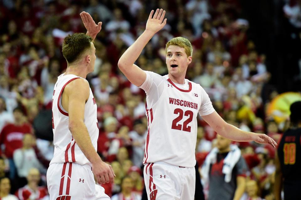 Dec 6, 2022; Madison, Wisconsin, USA;  Wisconsin Badgers forward Steven Crowl (22) high-fives forward Tyler Wahl (5) during the first half against the Maryland Terrapins at the Kohl Center. Mandatory Credit: Kayla Wolf-USA  TODAY Sports