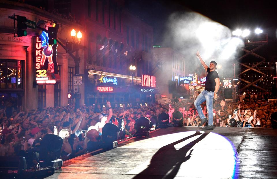 Luke Bryan performs a concert for fans in front of his new bar Luke's 32 Bridge at 3rd and Broadway Monday Sept. 10, 2018, in Nashville, Tenn.