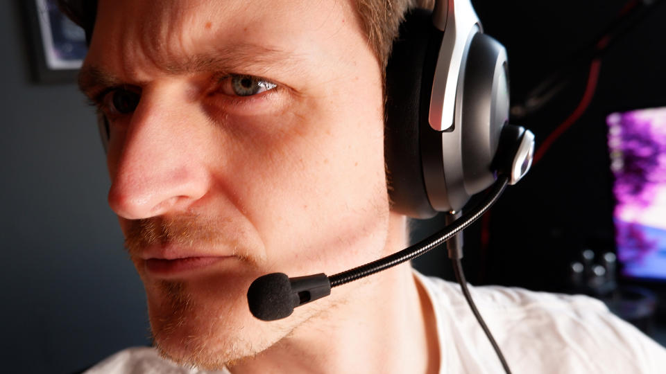 A person wearing the AceZone A-Spire gaming headset with microphone extended.