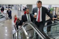 FILE PHOTO: U.S. FCC Chairman Pai speaks with Senator Cruz as they walk through the subway system at the U.S. Capitol in Washington