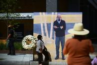 <p>A woman stands in front of a large photograph of Lewis, taken at his last public appearance. Lewis visited the newly renamed Black Lives Matter Plaza in Washington, D.C. last month. </p>