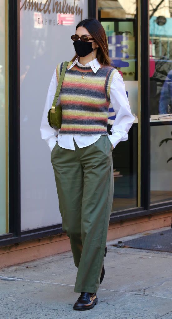 <p>Before her evening out, Jenner stayed on androgynous theme in this Grandad-chic ensemble, complete with knitted vest from Mango.</p><p><a class="link " href="https://shop.mango.com/gb/women/cardigans-and-sweaters-gilets/multicoloured-knitted-gilet_87064057.html" rel="nofollow noopener" target="_blank" data-ylk="slk:SHOP KNITTED VEST NOW">SHOP KNITTED VEST NOW</a></p>