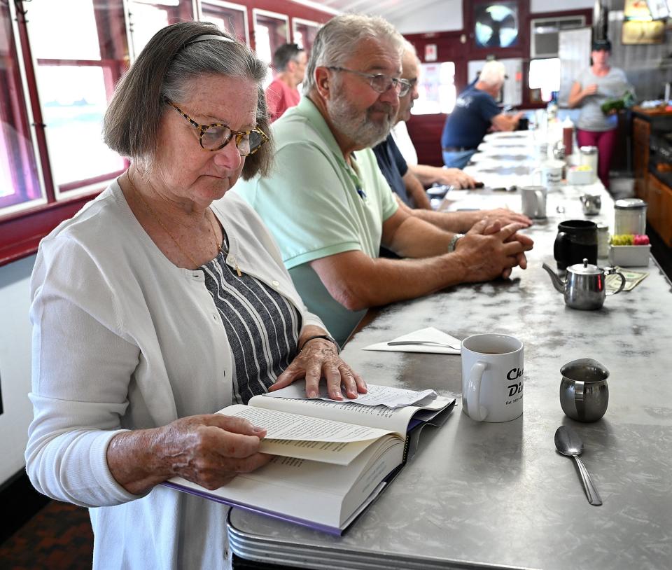 Paula Melican of Auburn reads a book while waiting for her breakfast at  Chet's Diner in Northborough, July 13, 2022.  