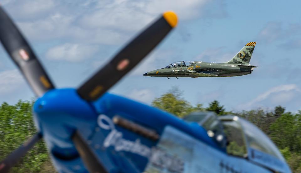 A high-performance Aero L-39C Albatros jet makes a low pass behind a North American P-51D Mustang during the Gathering of Warbirds event at Waukesha County Airport on Saturday, May 25, 2019. The annual family-friendly event features historic and modern military aircraft, aircraft tours and rides, and educational activities for all ages.