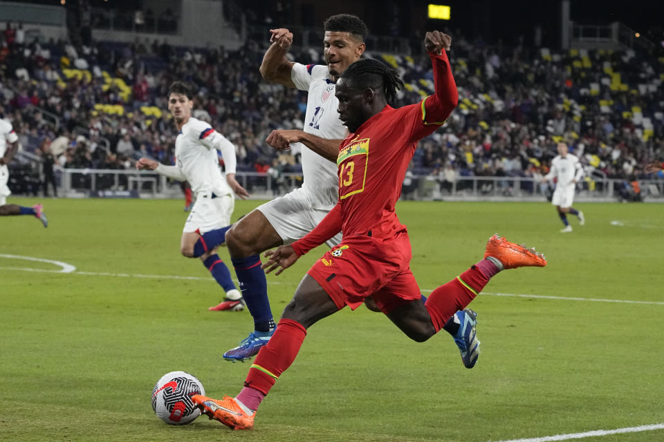 Ghana midfielder Joseph Paintsil (13) tries to get the ball past United States defender Miles Robinson, left, during the first half of an international friendly soccer match Tuesday, Oct. 17, 2023, in Nashville, Tenn. (AP Photo/George Walker IV)