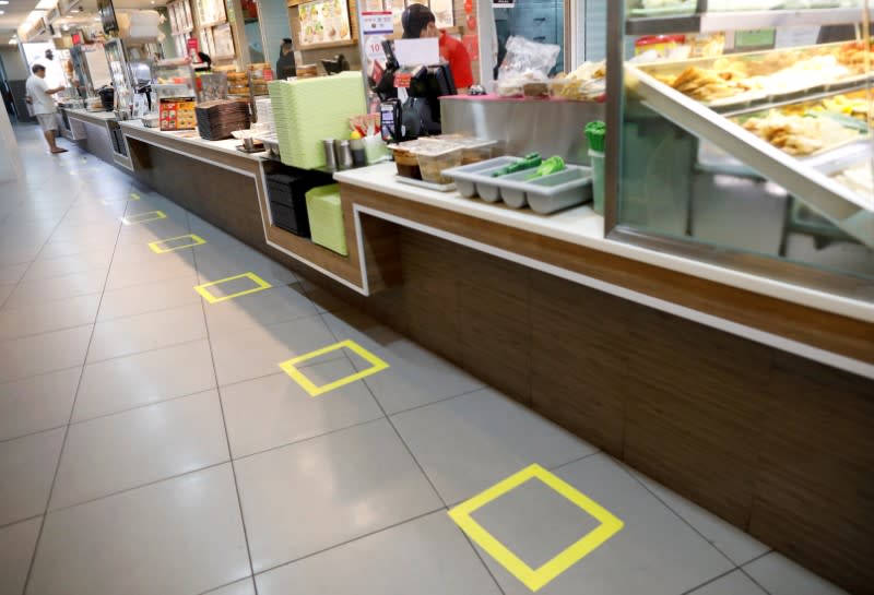 Taped-off areas for customers to distance themselves from each other are seen at a food court due to the outbreak of the coronavirus disease (COVID-19), in Singapore