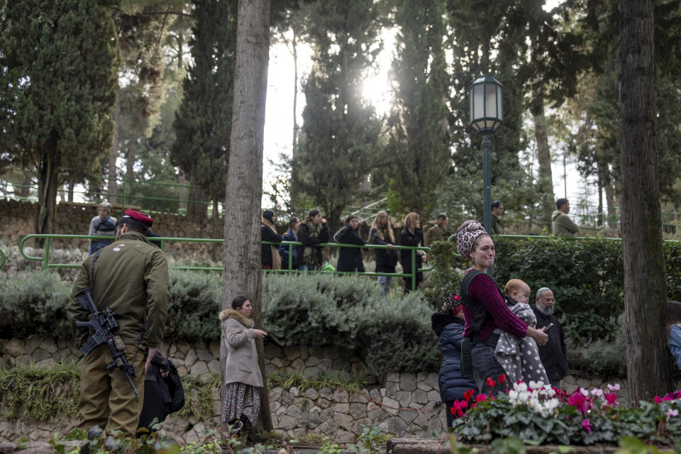 Mourners attend the funeral of reservist Gavriel Shani during his funeral at Mt. Herzl military cemetery in Jerusalem, Wednesday, Jan. 31, 2024. Shani, 28, was killed during Israel's ground operation in the Gaza Strip, where the Israeli army has been battling Palestinian militants in the war ignited by Hamas' Oct. 7 attack into Israel. (AP Photo/Ohad Zwigenberg)