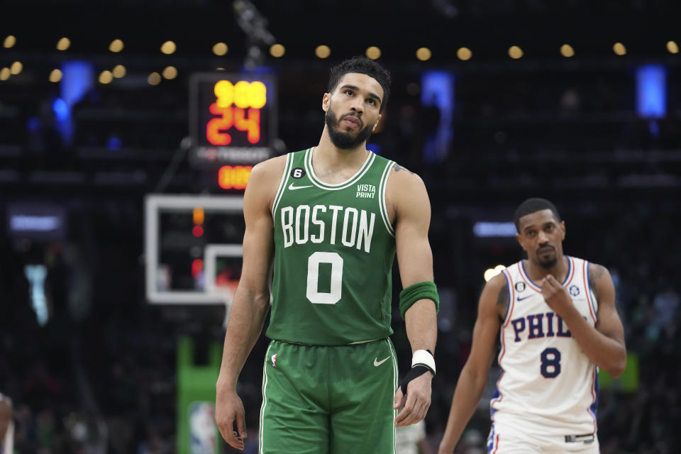 Boston Celtics forward Jayson Tatum (0) walks ahead of Philadelphia 76ers guard De'Anthony Melton (8) during the second half of Game 7 in the NBA basketball Eastern Conference semifinals playoff series, Sunday, May 14, 2023, in Boston. (AP Photo/Steven Senne)