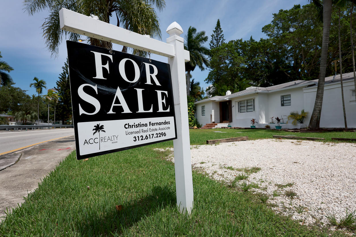 MIAMI, FLORIDA - JUNE 21: A 'for sale' sign hangs in front of a home on June 21, 2022 in Miami, Florida. According to the National Association of Realtors, sales of existing homes dropped 3.4% to a seasonally adjusted annualized rate of 5.41 million units. Sales were 8.6% lower than in May 2021. As existing-home sales declined, the median price of a house sold in May was $407,600, an increase of 14.8% from May 2021. (Photo by Joe Raedle/Getty Images)