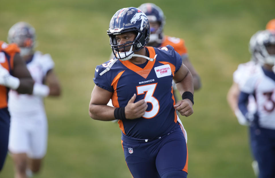 Denver Broncos quarterback Russell Wilson takes part in drills during a voluntary veteran minicamp football practice Monday, April 25, 2022, at the NFL team's headquarters in Englewood, Colo. (AP Photo/David Zalubowski)