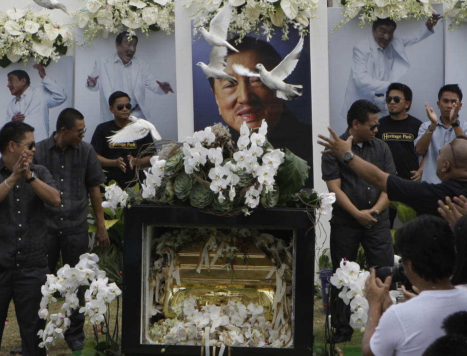 Doves fly over the tomb of the country’s "King of Comedy", Rodolfo Vera Quizon Sr., locally known as "Dolphy", during funeral rites at a cemetery in Taguig, south of Manila, Philippines on Sunday July 15, 2012. Quizon starred in more than 200 films in his 66-year career. The 83-year-old died Tuesday of multiple organ failure, kidney ailments and complications from pneumonia.(AP Photo/Aaron Favila)