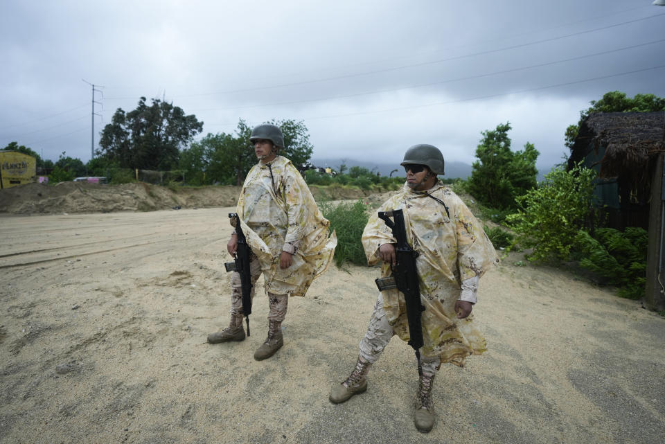 Mexican soldiers guard next to avenue flooded by the rains of Hurricane Norma in San Jose del Cabo, Mexico, Saturday, Oct. 21, 2023. Norma had weakened and was downgraded to Category 1 on the hurricane wind scale. It was located 25 miles west of Cabo San Lucas storm with winds of 85 mph (140 kmh) and expected to make landfall on Saturday, according to the U.S. (AP Photo/Fernando Llano)