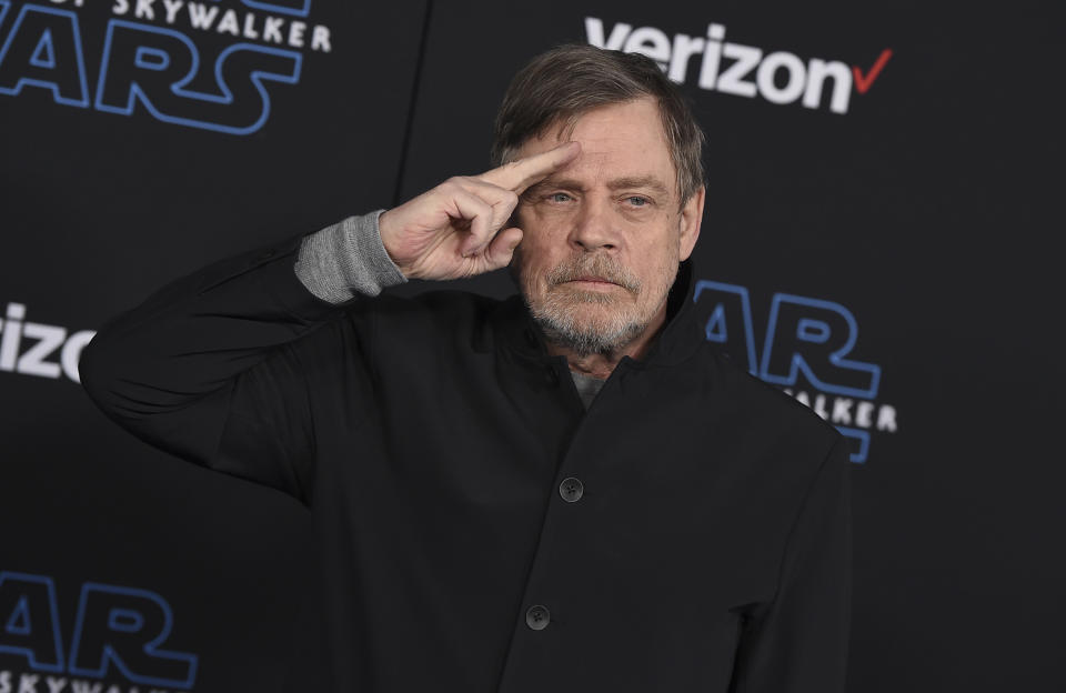 FILE - Mark Hamill salutes as he arrives at the world premiere of "Star Wars: The Rise of Skywalker" in Los Angeles on Dec. 16, 2019. When air raid alarms sound in Ukraine, they also trigger a downloadable app that has been voiced by “Star Wars” actor Mark Hamill. With his gravely but also calming baritone, he urges people to take cover. He also tells them when the danger has passed, signing off with “May the Force be with you.” In an interview with The Associated Press, the actor said he’s admiring Ukraine's resilience from afar in California.(Jordan Strauss/Invision/AP, File)