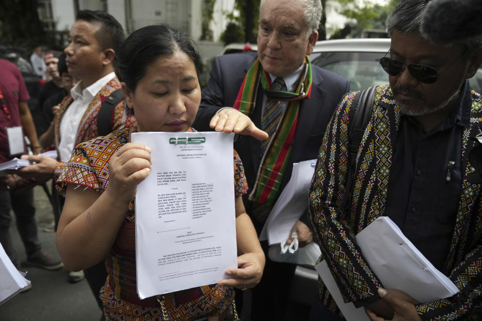 Burmese Zing Raltu holds documents before filing a criminal complaint against Myanmar's top generals at the Department of Justice in Manila, Philippines on Wednesday Oct. 25, 2023. Relatives of victims of alleged war crimes committed by Myanmar’s military filed a criminal complaint in the Philippines against their nation’s ruling generals in a desperate attempt to test whether such a case could succeed outside the violence-wracked country. (AP Photo/Aaron Favila)