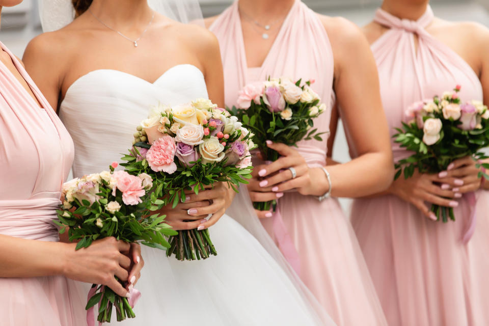 bride and bridesmaids holding bouquets 