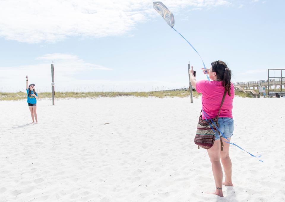 Casey Conger, of Enterprise, Alabama, helps her daughter Allison, 10, to launch her kite in the sandy area next to the parking lot at Navarre Beach on Friday, October 5, 2018.  Santa Rosa County may spend a portion of the $3 million bed tax revenue overage on improving the facilities in the area near the fishing pier.