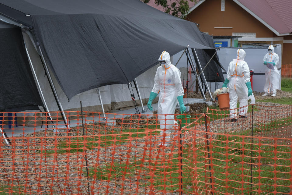 Medical workers walk inside the Ebola isolation center of Madudu Health Center III, in the village of Madudu, in the Mubende district of Uganda Tuesday, Nov. 1, 2022. Ugandan health officials say they have controlled the spread of a strain of Ebola that has no proven vaccine, but there are pockets of resistance to health measures among some in rural communities where illiteracy is high and restrictions on movement and business activity have left many bitter. (AP Photo/Hajarah Nalwadda)