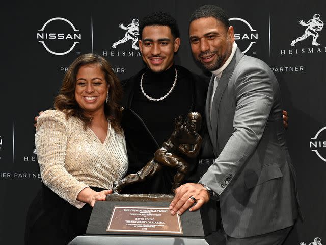 <p>Bryan Bedder/Getty</p> Bryce Young and parents Julie Young and Craig Young during the 2021 Heisman Trophy Winners press conference.