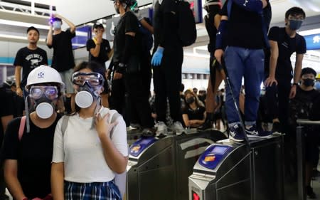 Protest at Yuen Long MTR station, the scene of an attack by suspected triad gang members a month ago, in Hong Kong