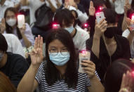Pro-democracy students raise a three-finger symbol of resistance salute and hold mobile phones with flashlights switched on†during a protest at Chulalongkorn University in Bangkok, Thailand, Friday, Aug, 14, 2020. Student activists at Thailand's most prestigious university defied a ban by college administrators to stage an anti-government rally Friday, even as a prominent protest leader was arrested elsewhere for his involvement in a previous demonstration. (AP Photo/Sakchai Lalit)