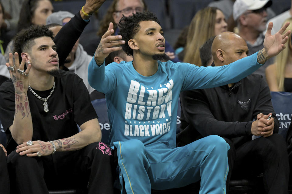 Charlotte Hornets guard LaMelo Ball, left, and guard James Bouknight react after a call during the first half of an NBA basketball game against the Indiana Pacers, Sunday, Feb. 4, 2024, in Charlotte, N.C. (AP Photo/Matt Kelley)