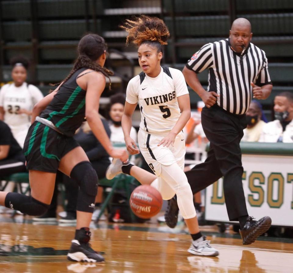 Pinkston guard Victoria Flores (5) drives the ball against Kennedale guard Reagan Jackson (3) during the first half of a 4A Region 2 quarterfinal basketball game at DeSoto High School in DeSoto, Texas, Wednesday, Feb. 24, 2021. Pinkston led Kennedale 19-11 at the half. (Special to the Star-Telegram Bob Booth)