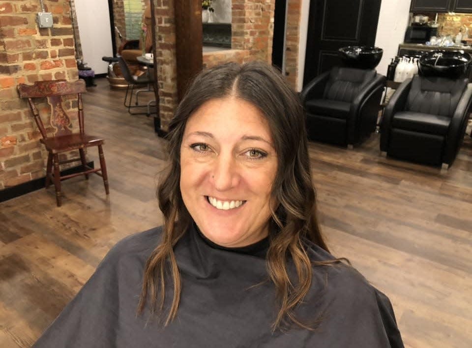 Sarah Proffitt of Waverly strikes a pose in The Apothic Company hair salon in Petersburg on Friday, Sept. 1.