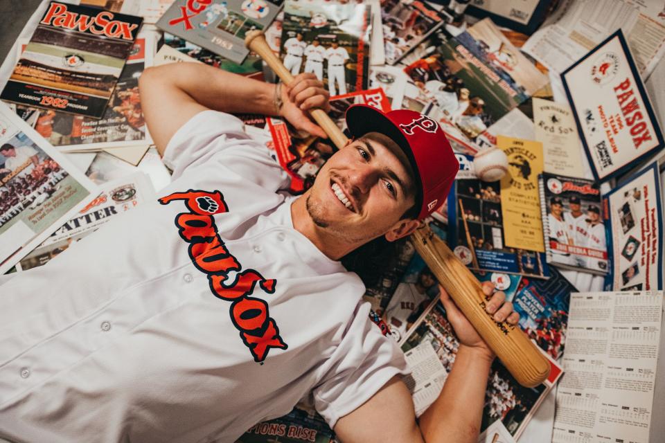 Ryan Fitzgerald basks in memorabilia from the Pawtucket Red Sox, while donning a PawSox shirt and cap.