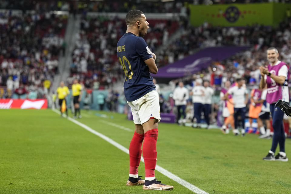 France's Kylian Mbappe celebrates scoring his side's third goal during the World Cup round of 16 soccer match between France and Poland, at the Al Thumama Stadium in Doha, Qatar, Sunday, Dec. 4, 2022. (AP Photo/Martin Meissner)