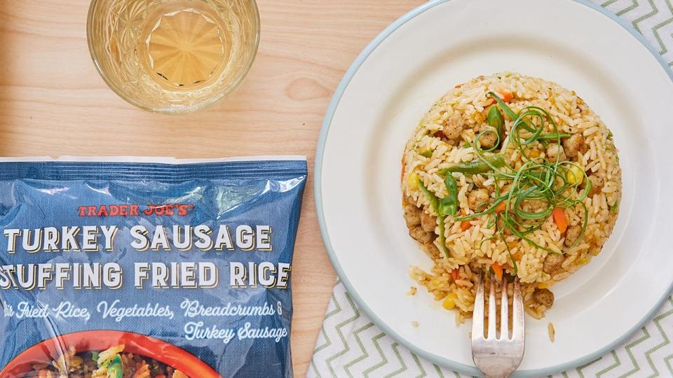 trader joe's turkey sausage stuffing fried rice on a plate, formed into a round shape with a fork digging into one side