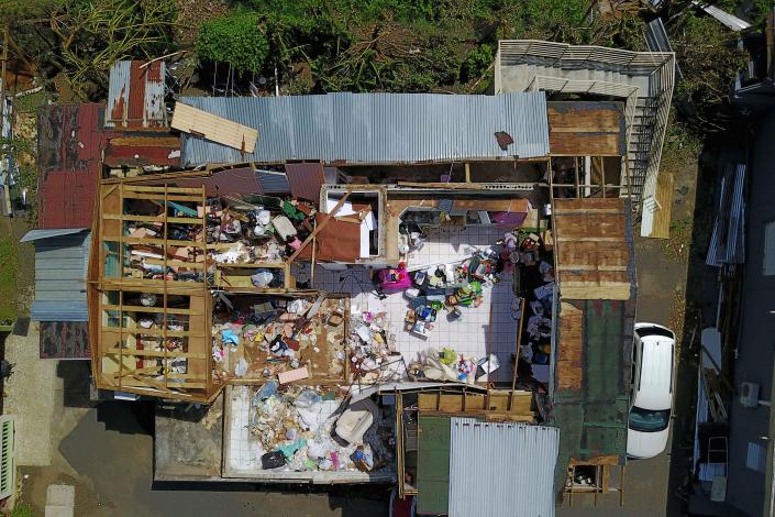<p>A house destroyed by hurricane winds is seen in Toa Alta, southwest of San Juan, Puerto Rico, on September 24, 2017 following the passage of Hurricane Maria. Authorities in Puerto Rico rushed on September 23, 2017 to evacuate people living downriver from a dam said to be in danger of collapsing because of flooding from Hurricane Maria. (Photo: Ricardo Arduengo/AFP/Getty Images) </p>